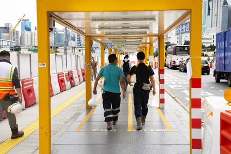 Chinese and foreigners people walking to Ferry Boat station crossing Victoria Harbour between kowloon and Hong Kong island on September 10, 2018 in Hong Kong, Chinaのeditorial素材