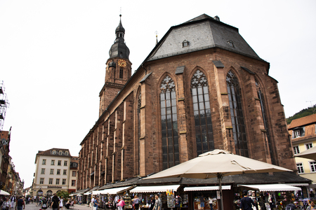 German people and foreign travelers walking visit and sit eat and drink at square old market near church of the holy spirit on August 25, 2017 in Heidelberg, Germanyのeditorial素材