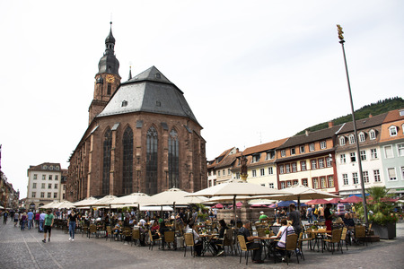 German people and foreign travelers walking visit and sit eat and drink at square old market near church of the holy spirit on August 25, 2017 in Heidelberg, Germanyのeditorial素材