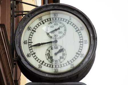 Classic retro vintage metal clock hanging on front of building at heidelberger market or marktplatz on August 25, 2017 in Heidelberg, Germanyのeditorial素材