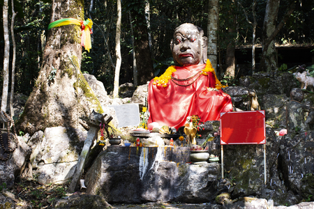 Demon or Giant angel statue in forest top of mountain for thai people visit respect praying at Wat Phra That Doi Tungの写真素材