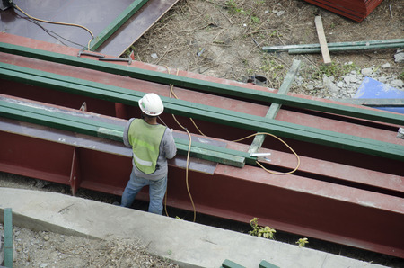 Asian thai people worker welding steel in construction site making reinforcement metal framework for...