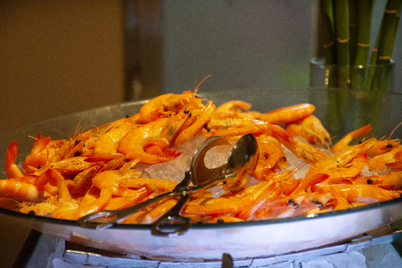 Seafood bar at buffet food line in restaurant at night time in Bangkok, Thailandの写真素材
