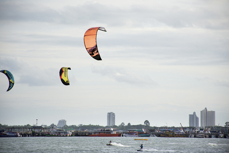 Thai athletes and foreigner people practicing sports and playing kiteboarding or sea kite in the ocean at Ban Pae beach on July 3, 2018 in Rayong, Thailandのeditorial素材
