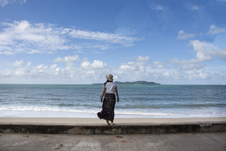 Traveler thai women playing relax and posing for take photo on the beach with wind and wave in morning time at Ban Pae beach in Rayong, Thailandの写真素材