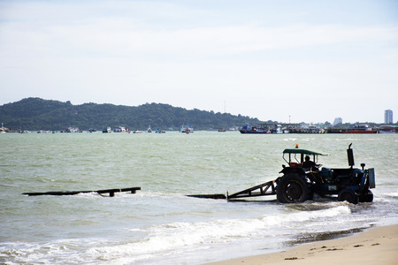 Thai people driving tractor go to the sea for keeping and move up speed boat go to store at Ban Pae beachの写真素材