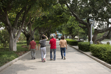 Chinese old people and friends walking relax on street in garden at Zhongshan public park in Shantou town or Swatow city on May 9, 2018 in Guangdong, Chinaの写真素材