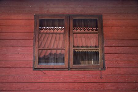 Classic retro vintage window on wall of wooden hut at the City of Phraya Lae the Brave in...