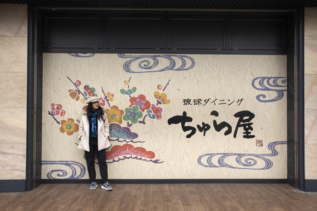 Tokyo, Japan - March 26, 2019 : Travelers thai women posing and portrait with wall art japanese style at front of Kamata station in morning timeのeditorial素材