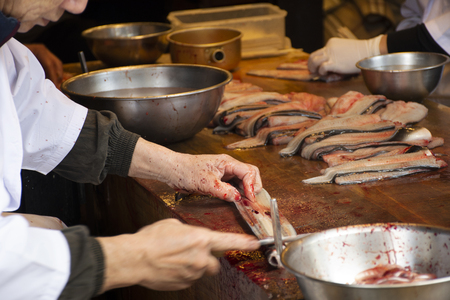 Tokyo, Japan - March 31, 2019 : Chef people killing and fillet eel fish for show customer and cooking kabayaki or eel grilled with sweet sauce in Naritasan Omote Sando or Old Japanese Narita town Chiba Prefecture in Tokyo, Japanのeditorial素材