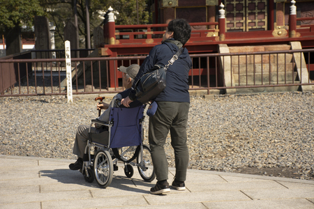 Tokyo, Japan - March 31, 2019 : Japanese family people push wheelchair and bring oldman father walking visit and praying in Naritasan Shinshoji Temple at Chiba Prefecture on March 31, 2019 in Tokyo, Japanのeditorial素材