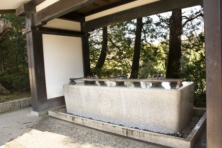 Tokyo, Japan - March 31, 2019 : Chozusha or Holy water in wash hand stone basin for people washing before go to inside japanese temple or Mitarashi ritual Naritasan Shinshoji or Narita Temple st Chiba Prefecture in Tokyo, Japanのeditorial素材
