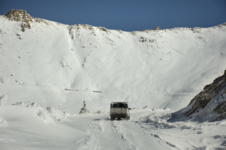 Indian and tibetan drive car and colorful truck on Khardung La Road in Himalaya mountain go to Nubra...