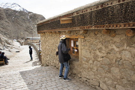Traveler thai women buy ticket from indian and tibetan people at tickets box for travel visit in Leh Stok Monastery or Gompa Palace at Leh Ladakh while winter season in Jammu and Kashmir, Indiaのeditorial素材