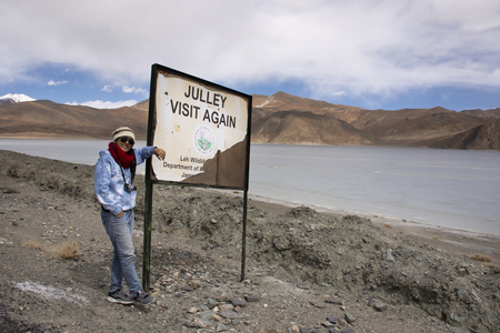 JAMMU KASHMIR, INDIA - MARCH 20 : Traveler thai woman travel visit for take photo with Himalaya mountain and Pangong Tso high grassland lake at Leh Ladakh on March 20, 2019 in Jammu and Kashmir, Indiaのeditorial素材