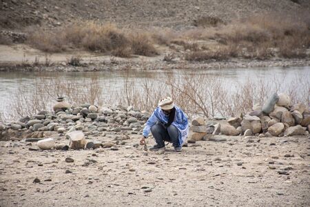 Travelers thai woman travel visit with landscape high range mountain and Sindhu or Indus River on Leh Manali and Srinagar Leh Highway while winter season at Leh Ladakh in Jammu and Kashmir, Indiaの写真素材