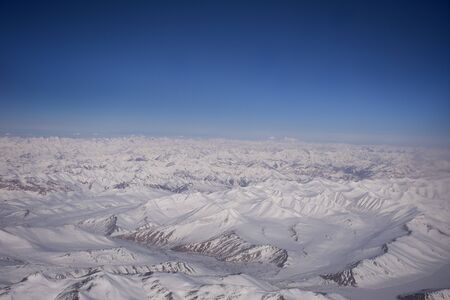 Aerial view landscape with himalaya range mountains from airplane flying from New delhi go to Kushokの写真素材