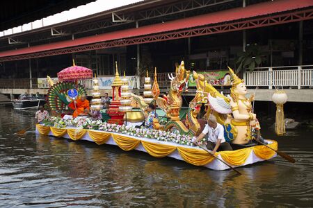 NONTHABURI, THAILAND - NOVEMBER 22 : Thai people praying put food and thing offerings to monks...