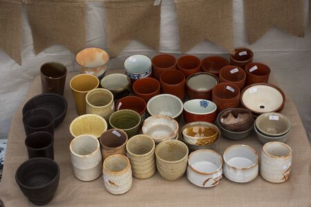 Sculpture ceramic tea cup and pot tea art for sale travelers people buy at street market in Bangkok, Thailandの写真素材