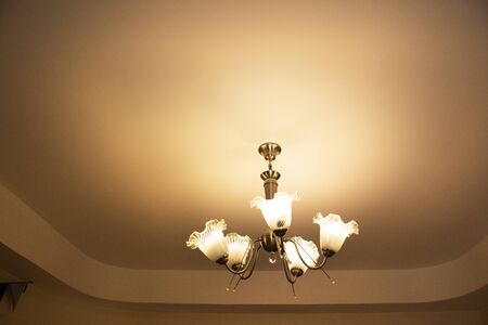Ceiling hanging lamp and interior decoration furniture in room of classic resort for travelers...