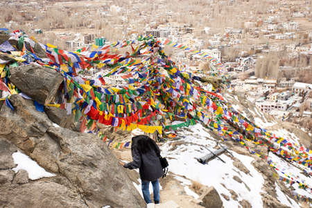 JAMMU KASHMIR, INDIA - MARCH 20 : Traveler thai women tied prayer and blessing flags on mount of Thiksey monastery and Namgyal Tsemo Gompa in Leh ladakh on March 20, 2019 in Jammu and Kashmir, Indiaのeditorial素材