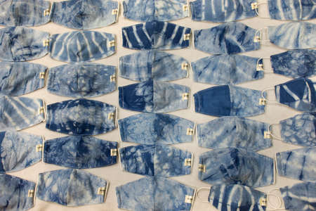 BANGKOK, THAILAND - APRIL 10 : Thai people making handmade fabric mask indigo natural color for sale...
