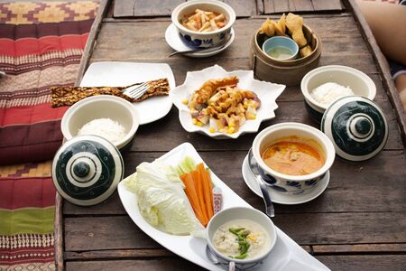 Thai local food fusion modern luxury style set for serve dinner meal to travelers and guest in dining terrace outdoor of restaurant at resort hotel in Thailandの写真素材