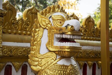 Golden singha statue guardian of Pagoda or Stupa of Wat Phra That Phanom temple for foreign traveler and thai people travel visit and respect praying in Nakhon Phanom, Thailandの写真素材