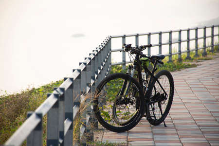Classic mountain bicycle stop on street of park outdoor at riverside Mekhong riverのeditorial素材