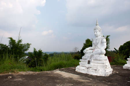 SAKON NAKHON, THAILAND - OCTOBER 2 : Buddha statue of Wat Phra Buddha Bat Nam Thip temple for thai people travelers travel visit respect praying at Phu Phan on October 2, 2019 in Sakon Nakhon, Thailandのeditorial素材