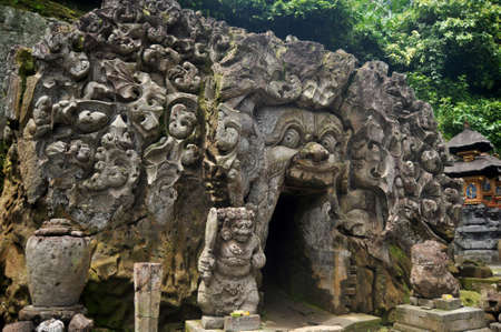 Ancient sculpture carving gate entrance tunnel of Goa Gajah or Elephant Cave significant Hindu...