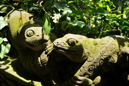 Art sculpture and carved antique deity angel god of hindu statue balinese style in Mandala Suci Wenara Wana or Ubud Sacred Monkey Forest Sanctuary at Ubud city in Bali, Indonesiaの写真素材