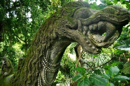 Art sculpture and carved antique deity angel god of hindu statue balinese style in Mandala Suci Wenara Wana or Ubud Sacred Monkey Forest Sanctuary at Ubud city in Bali, Indonesiaの写真素材
