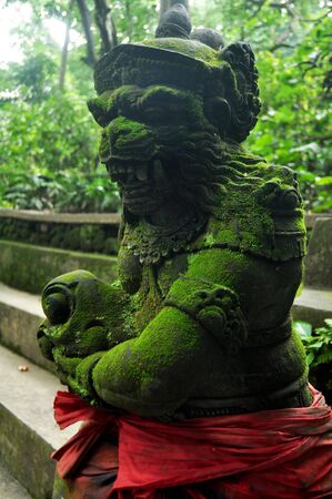 Art sculpture and carved antique deity angel god of hindu statue balinese style in Mandala Suci Wenara Wana or Ubud Sacred Monkey Forest Sanctuary at Ubud city in Bali, Indonesiaの写真素材