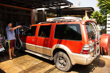 NONTHABURI, THAILAND - MAY 17 : Thai man people recreation work cleaning car wash at front of house...