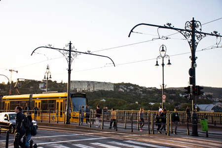 BUDAPEST, HUNGARY - SEPTEMBER 23 : Traffic road with train tram and Hungarian passengers and foreign travelers walking footpath beside Elizabeth Bridge road on September 23, 2019 in Budapest, Hungaryのeditorial素材