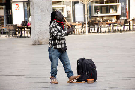 African American Gypsy playing flute music for show German people and foreign travelers at front of koln or kolne Central Hauptbahnhof railway station on September 11, 2017 in Cologne, Germanyのeditorial素材