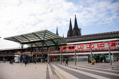 Landscape cityscape and German and foreign travelers walk at front of koln or kolne Central Hauptbahnhof railway station with Cologne Cathedral or Kolner Dom on September 11, 2017 in Cologne, Germanyのeditorial素材