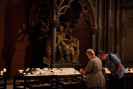 German people and foreigner travelers travel visit and burn candle for remember praying respect to Virgin Mary and Jesus at Cologne Cathedral or Kolner Dom on September 11, 2017 in Cologne, Germanyのeditorial素材