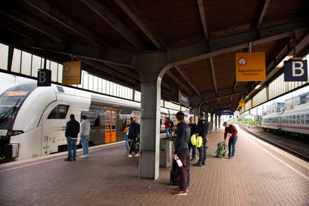 German people and foreign travelers walking waiting got to train in terminal at Dortmund Central...