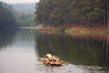 Thai people and travelers foreign travel visit rowing bamboo rafts in Pang Ung lake tour Pang Oung forest park or Switzerland of Thailand Ban Rak Thai on February 28, 2020 in Mae Hong Son, Thailandのeditorial素材