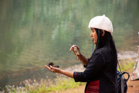 Travelers thai women journey travel visit and take photo between tour at Pang Ung lake in Pang Oung forest park or Switzerland of Thailand  in Chinese village Ban Rak Thai in Mae Hong Son, Thailandのeditorial素材