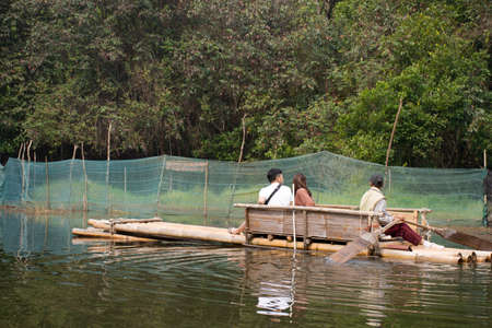 Thai people and travelers foreign travel visit rowing bamboo rafts in Pang Ung lake tour Pang Oung forest park or Switzerland of Thailand Ban Rak Thai on February 28, 2020 in Mae Hong Son, Thailandのeditorial素材