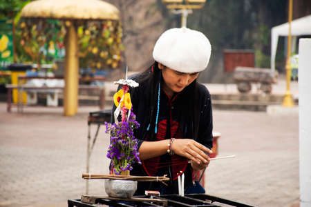 Travelers thai women travel visit and respect praying offerings to Stupa chedi and buddha statue pagoda at Wat Phra That Doi Kong Mu Temple in Maehongson hill valley city in Mae Hong Son, Thailandのeditorial素材