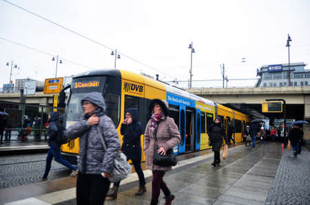Bus and tram railway stop station for send and receive german passengers people and foreign travelers wait and walk while raining storm at Dresden city on November 16, 2016 in Saxony state, Germanyのeditorial素材