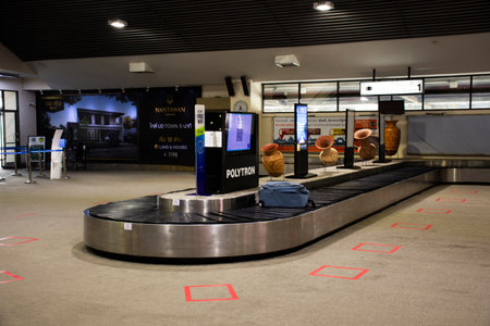 Thai people and foreigner travelers journey waiting receive bag and luggage on carousel conveyor at...