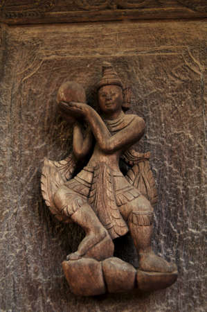 Wooden figure deity carving of Teakwood temple of Mandalay or Shwenandaw Monastery or Golden Palace Monastery for burmese people and foreign travelers travel visit in Mandalay of Myanmar or Burmaのeditorial素材