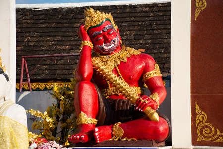 King vessavana or Kuvera red giant statue of Wat Phra That Doi Kham temple of the Golden Mountain...