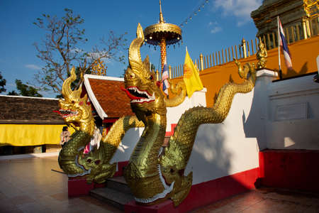 Naga Serpent and chedi pagoda stupa of Wat Phra That Doi Kham or Temple of the Golden Mountain for thai people and foreign travelers travel visit and respect praying at Mae Hia in Chiang Mai, Thailandのeditorial素材