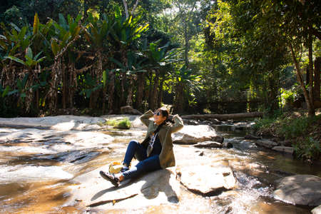 Travelers thai women people travel visit Mae sa waterfalls and rest relax outdoor in jungle wild...